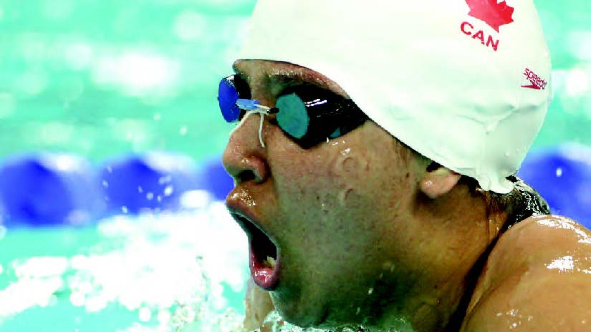 Stephanie McDougal comes up for air in a swimming race.